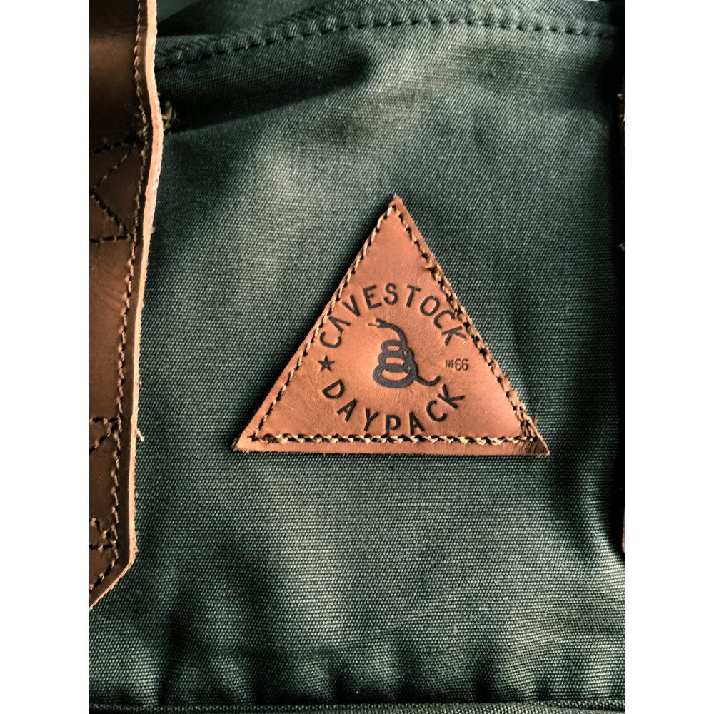 Close-up of the Faraday Cavestock Daypack No. 66 olive backpack logo patch.