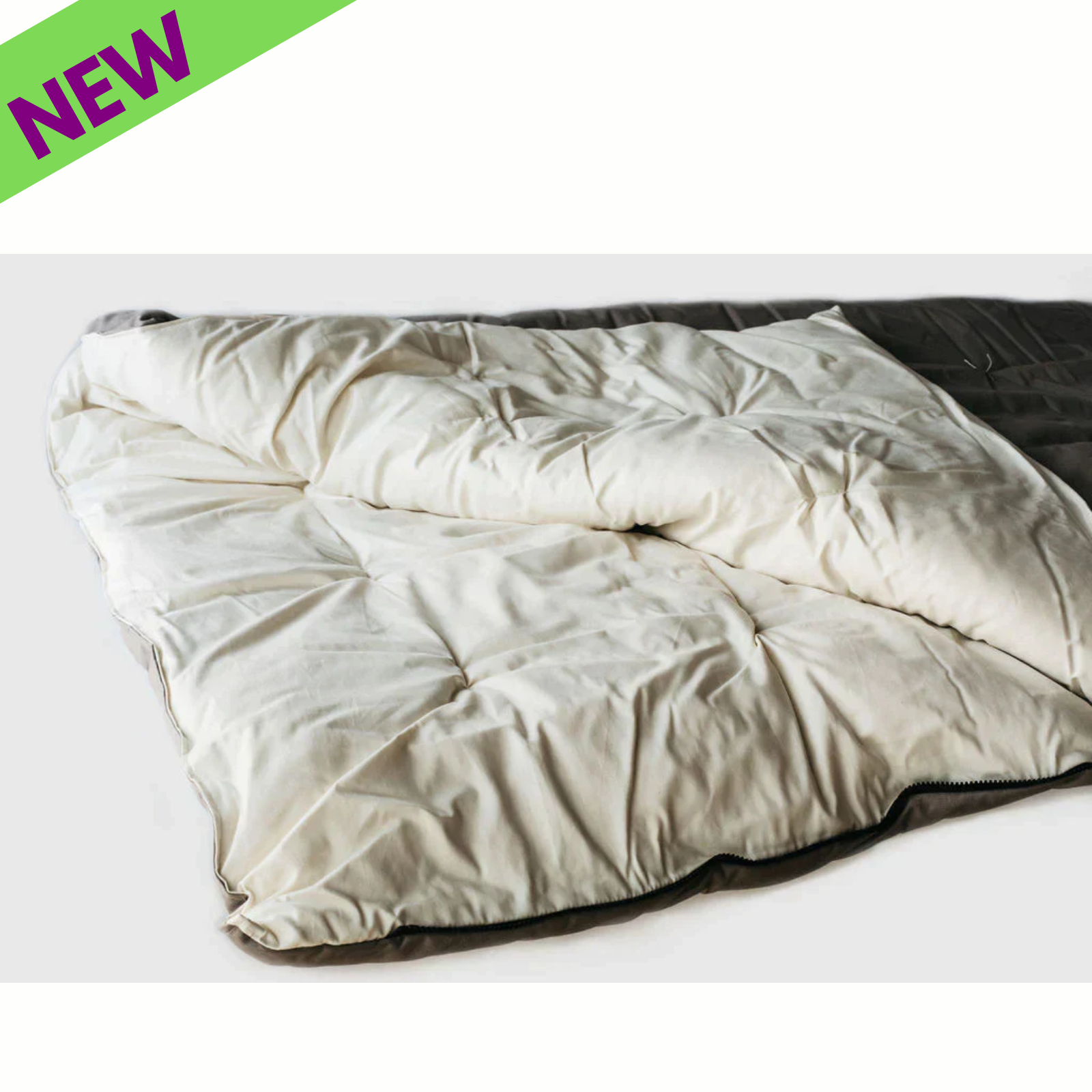 Holy Lamb Natural Wool Sleeping Bag warm cozy kids size eco friendly sleeping bag displayed on a bed.