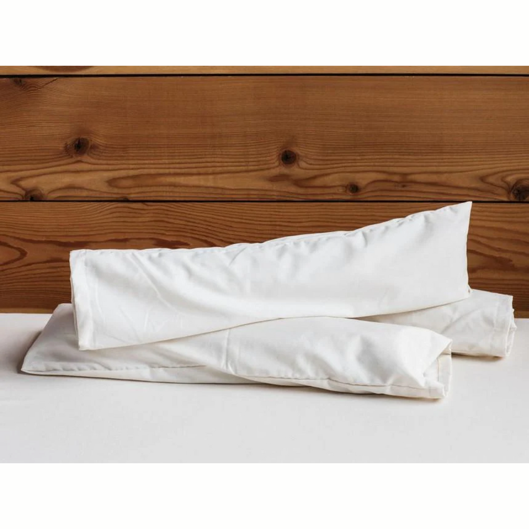 Holy Lamb Organics Neck Roll Supportive Cushion for Sleep and Relaxation on a wooden surface.