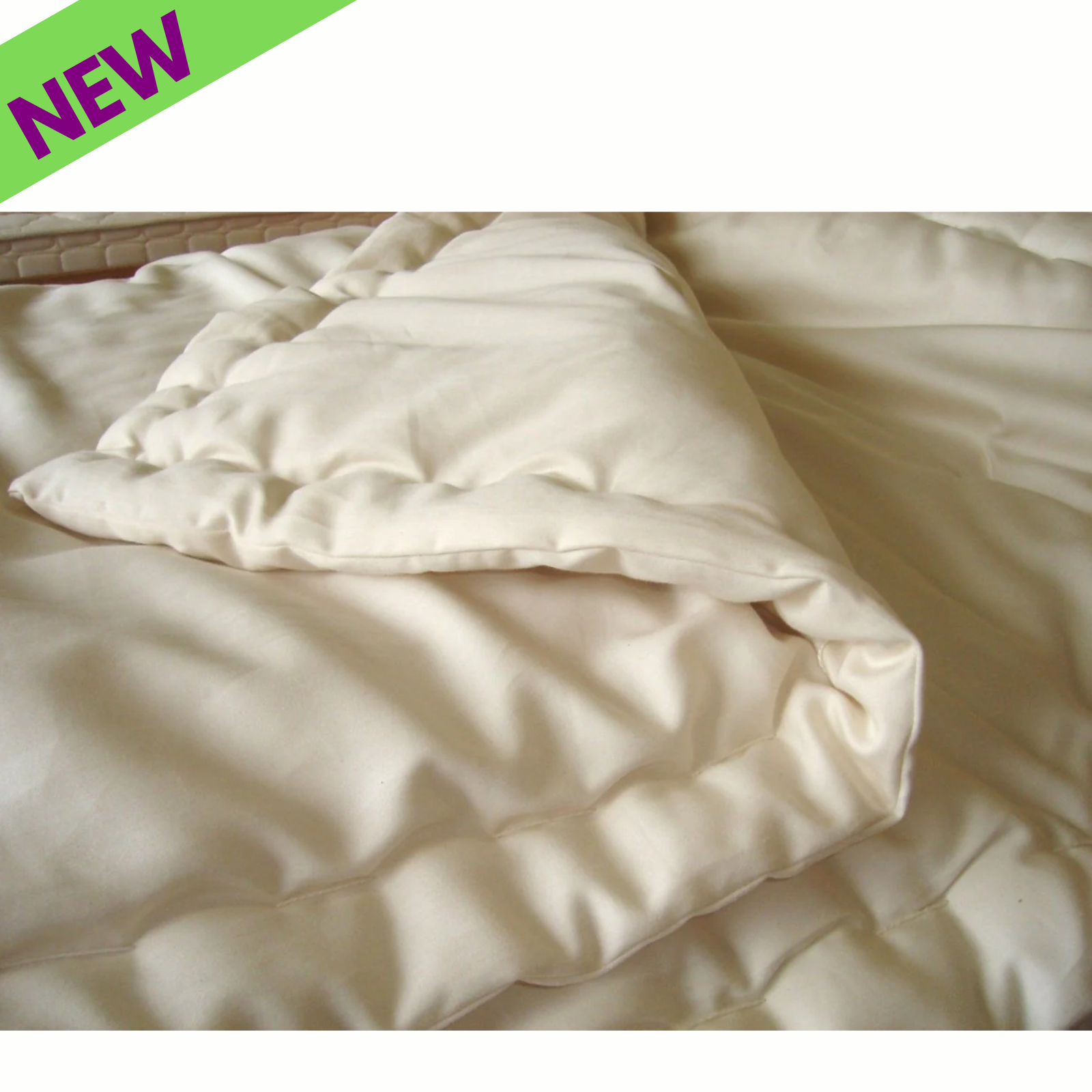 Holy Lamb Organic Wool Comforter in cream color, showcasing its soft organic wool texture and warm quilted design.