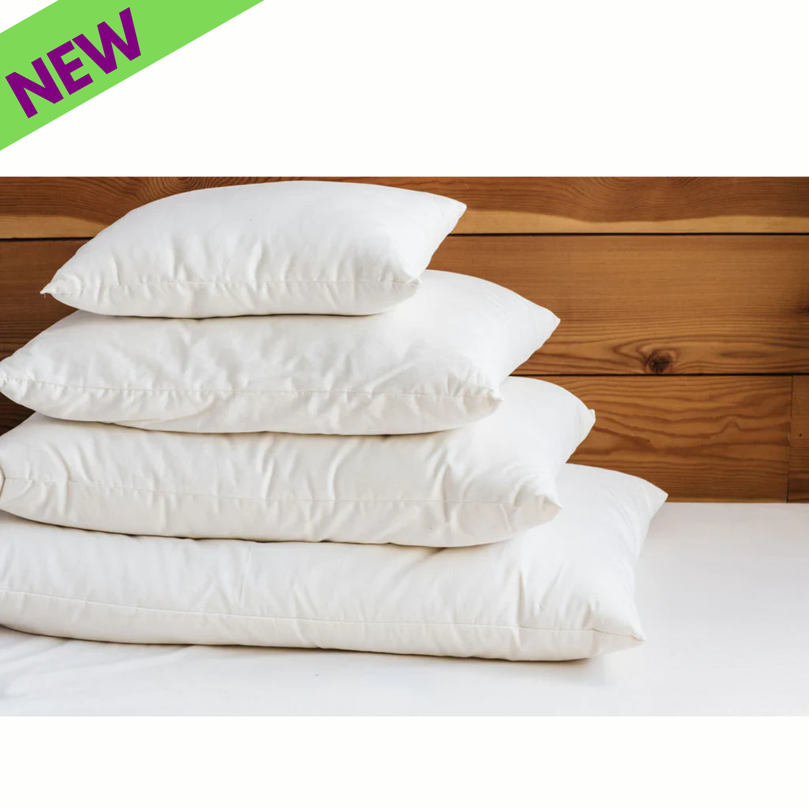 Holy Lamb Organics Bed Pillows stacked on a surface, showcasing the natural eco wool-filled design, in a cozy setting.