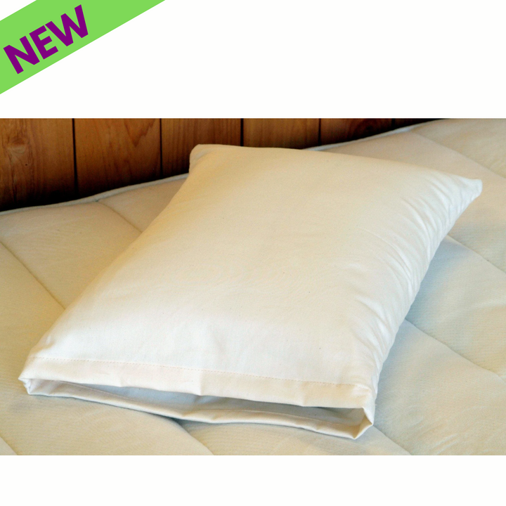Holy Lamb Organics Travel Pillow Natural Cotton and Wool on a bed, showcasing new arrival features, 12.5" x 17.5".