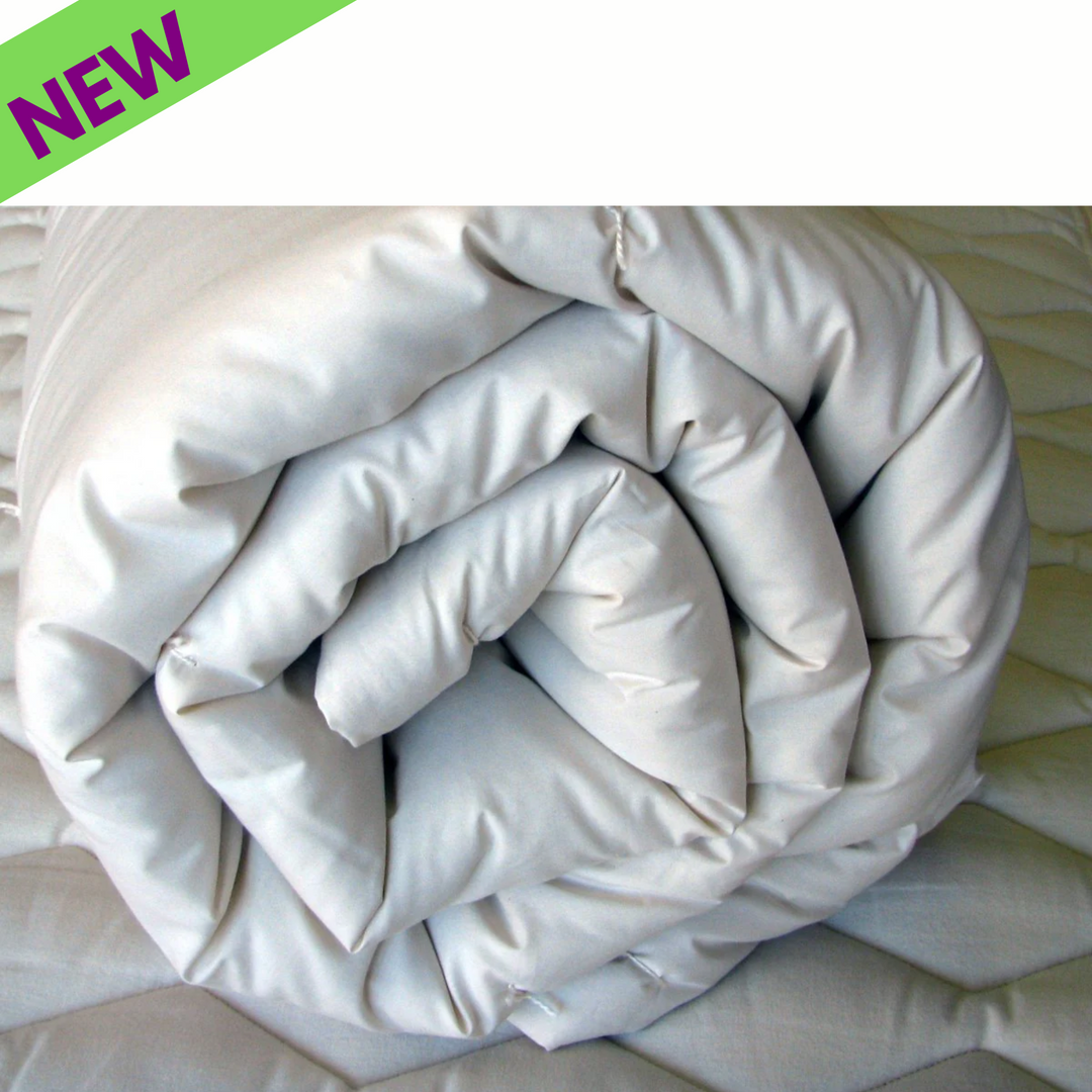 Holy Lamb Organic Wool Comforter rolled up, showcasing its soft texture and new design.