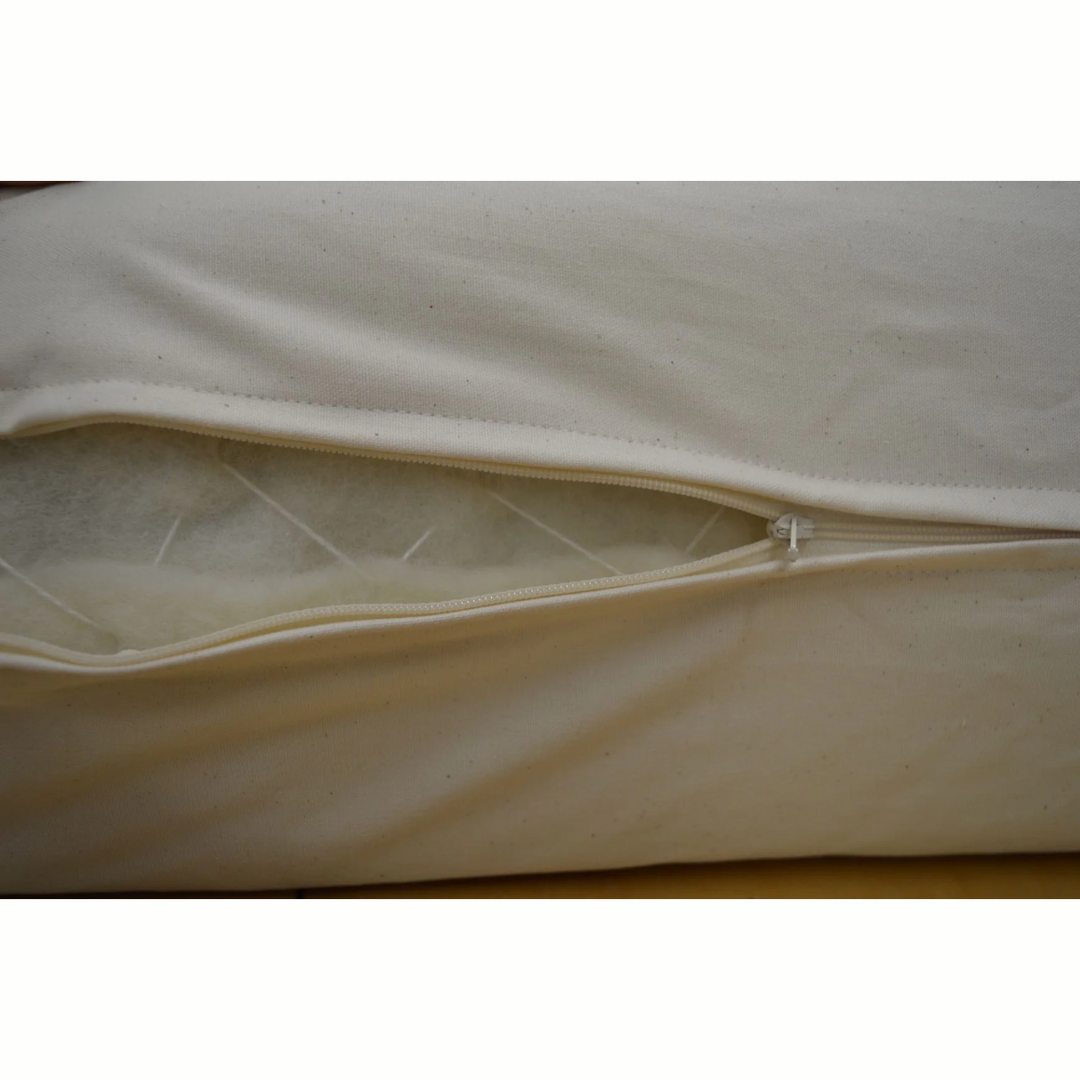 Close-up of the Holy Lamb Organics Wool &amp; Latex Mattress zipper showcasing natural wool filling.