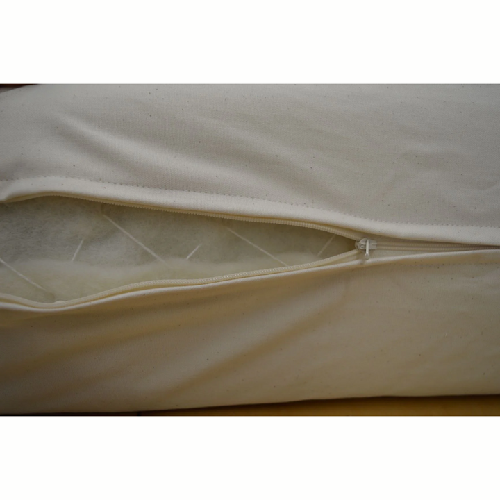 Close-up of the Holy Lamb Organics Wool &amp; Latex Mattress zipper showcasing natural wool filling.
