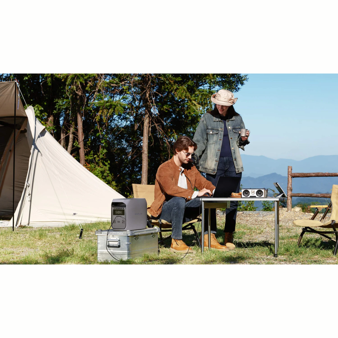 EcoFlow DELTA 3 Classic Portable Power Station in use outdoors at a campsite with two people.