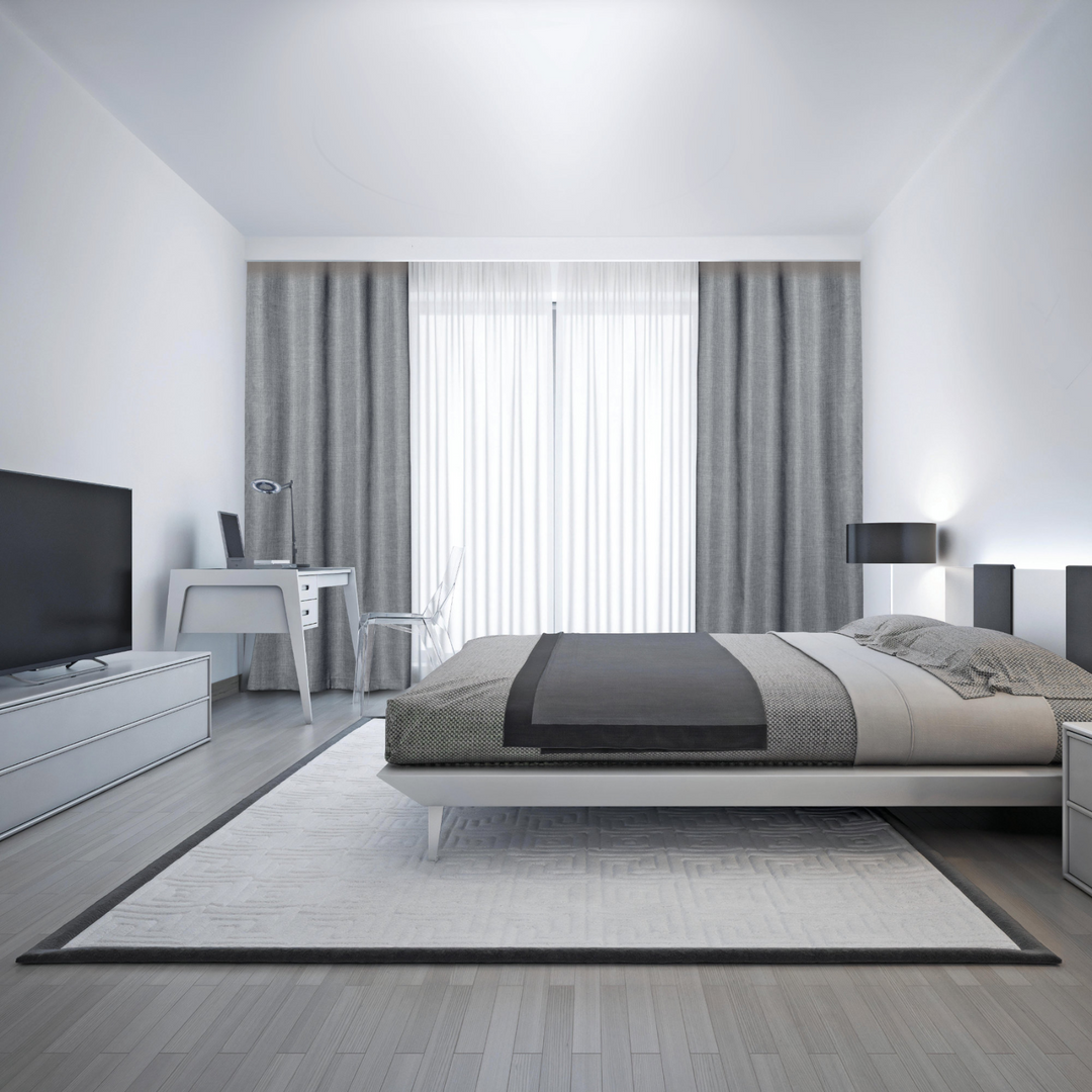 A modern bedroom featuring Faraday MAX Blackout CYBER Faraday RF EMF Shielding Curtains, with stylish decor and furniture.