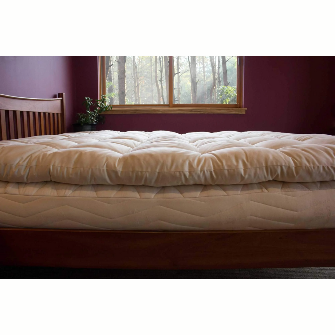 Holy Lamb Quilted Topper Cal King Size on a bed, showcasing its plush, organic design and comfortable features.