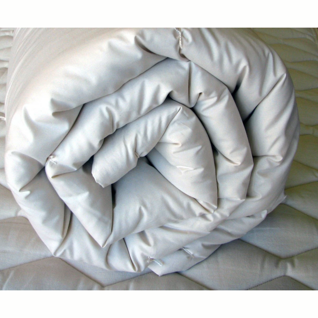 Holy Lamb Wool Comforter rolled and ready for use, showcasing its organic materials and plush design.