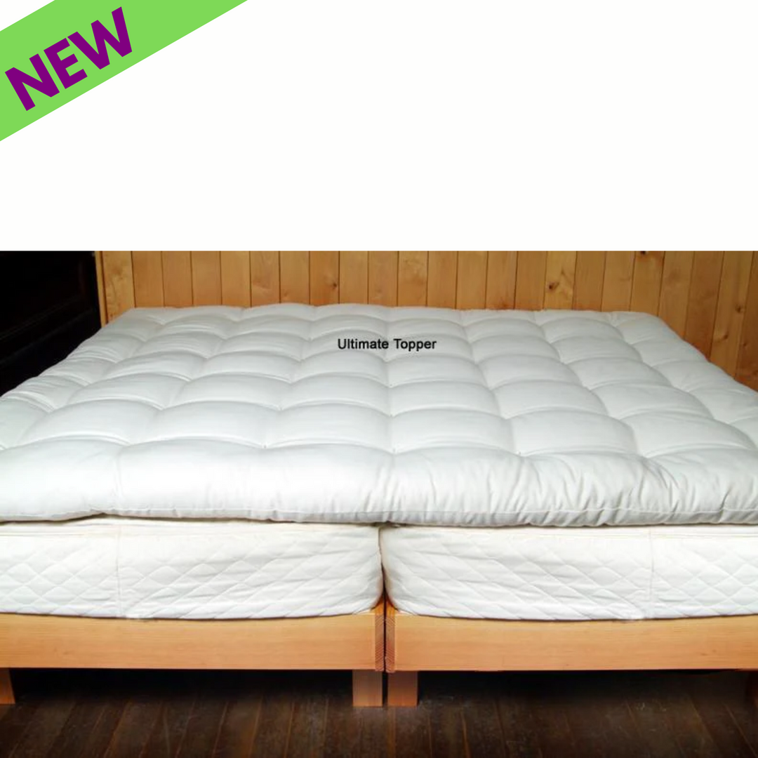 Holy Lamb Organics Quilted Mattress Topper on a bed, showcasing its natural, luxurious, and fluffy design for ultimate comfort.