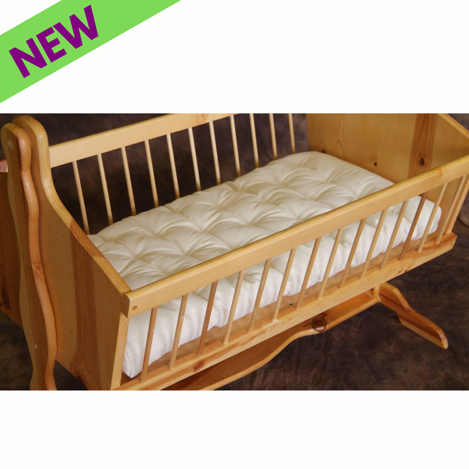 Holy Lamb Organics Bassinet Mattress in a wooden bassinet, showcasing natural eco wool design for newborn comfort.
