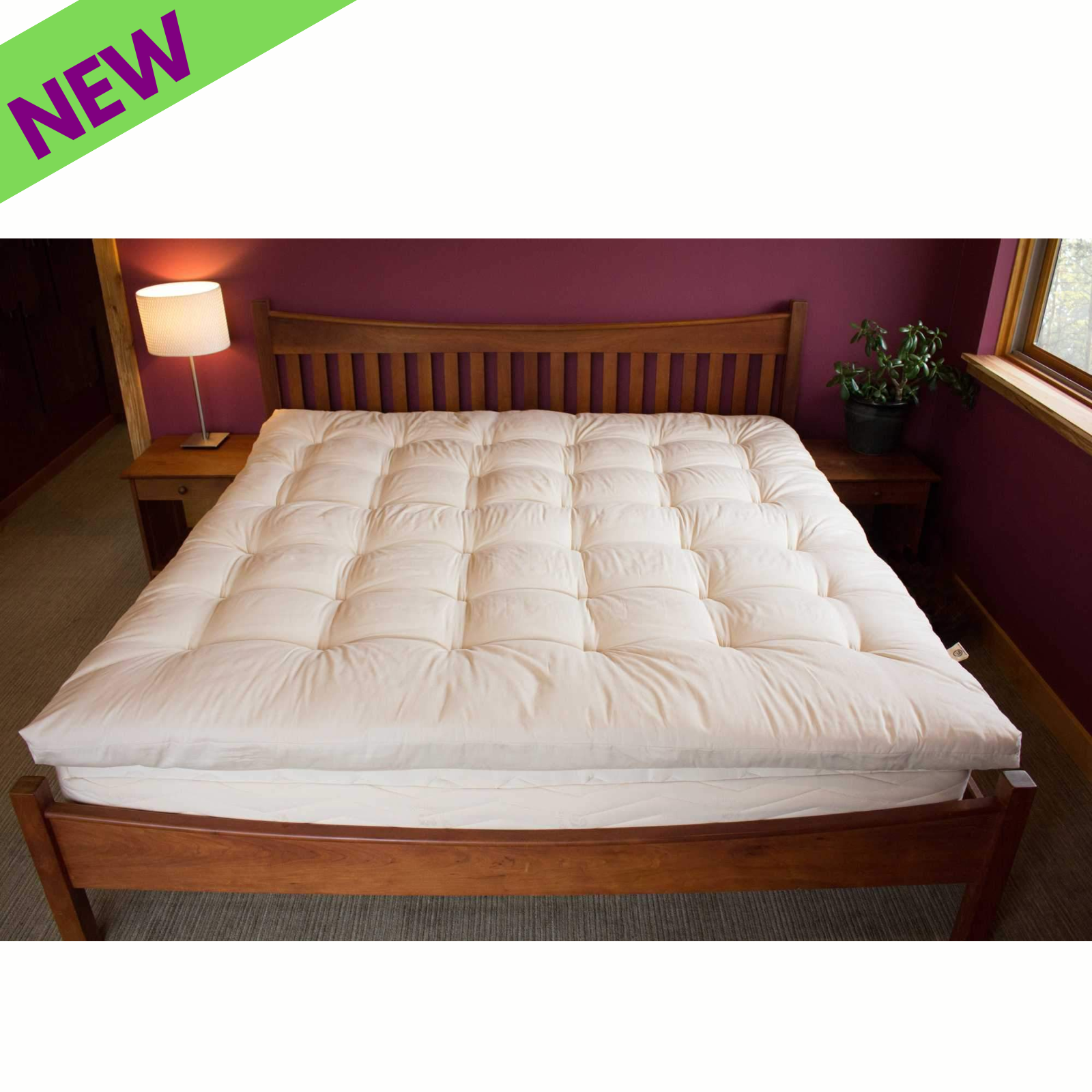 Holy Lamb Quilted Topper Cal King Size on a wooden bed with lamp and plant.