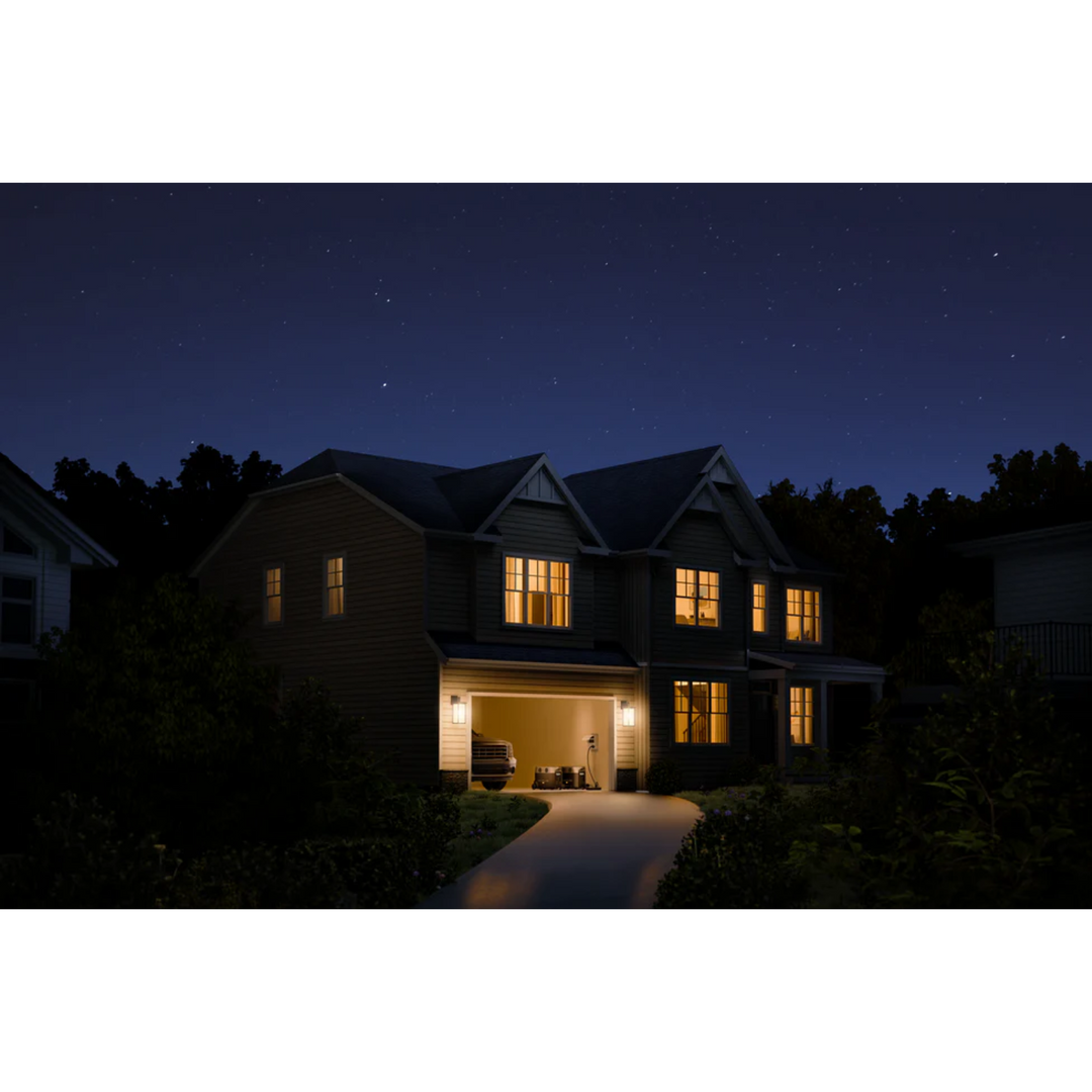 EcoFlow DELTA Pro Portable Power Station powering a home at night with illuminated windows.