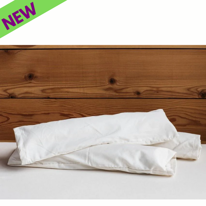 Holy Lamb Organics Neck Roll Supportive Cushion displayed against a wooden background, labeled as &