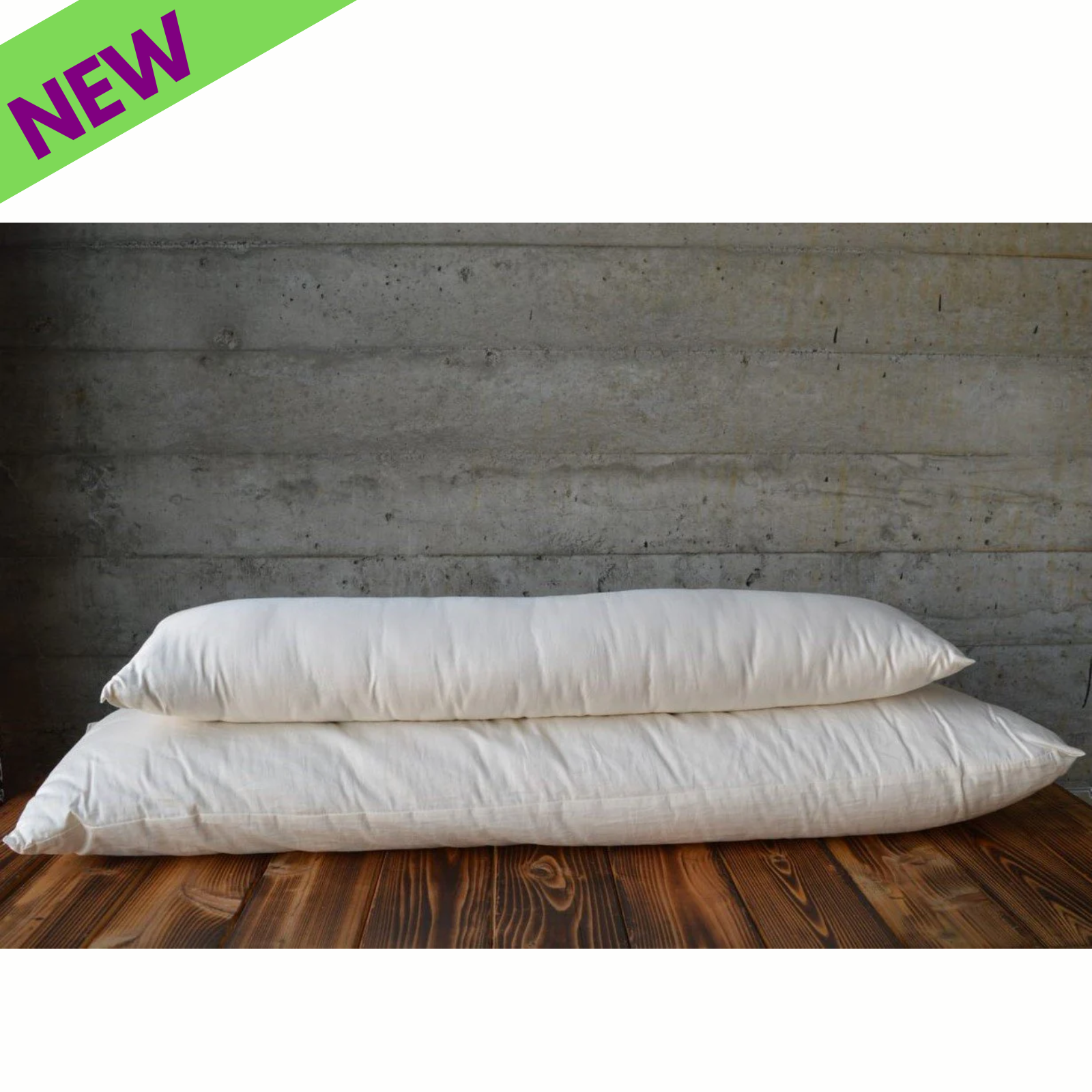 Holy Lamb Organics Body Pillow wool-filled, showcasing two new full-size pillows on a wooden surface.