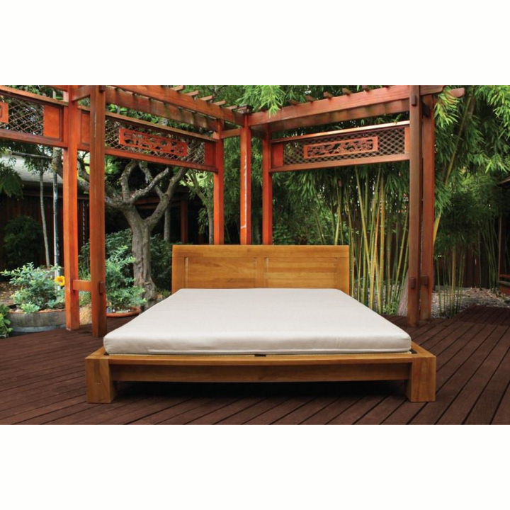 Soaring Heart Organic Latex Shikibuton Full displayed on a wooden bed frame in a serene outdoor setting.