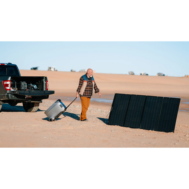 EcoFlow DELTA Pro 3 and Solar Panel Set with a man pulling a portable solar panel near a truck in an outdoor setting.