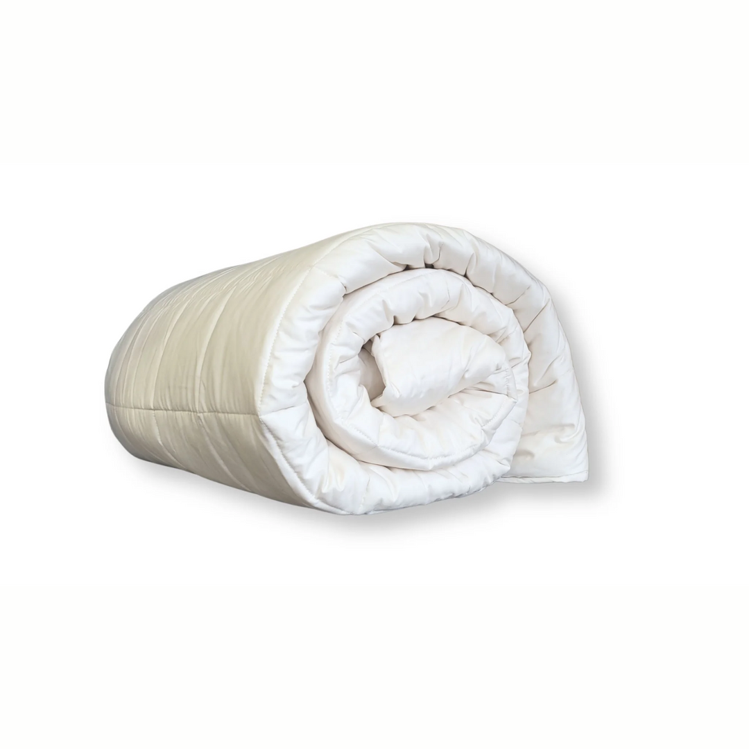 Soaring Heart Quilted Cotton comforter rolled up, featuring soft and breathable crib bedding.