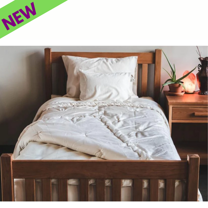 Holy Lamb Organics Comforter on a bed, showcasing organic warmth with a natural aesthetic.