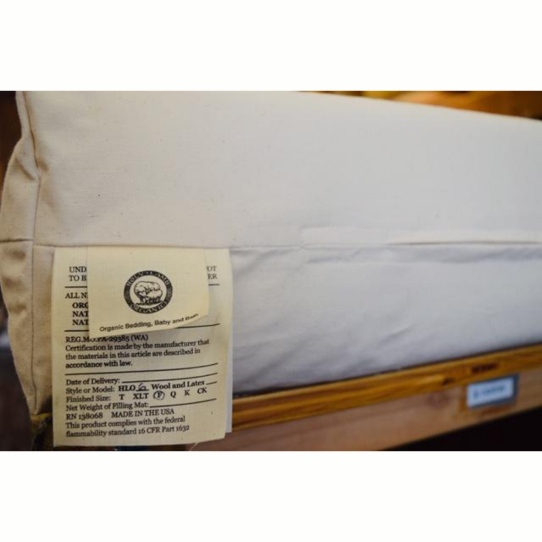 Holy Lamb Organics Wool &amp; Latex Mattress label showing organic certification details and manufacturer information.