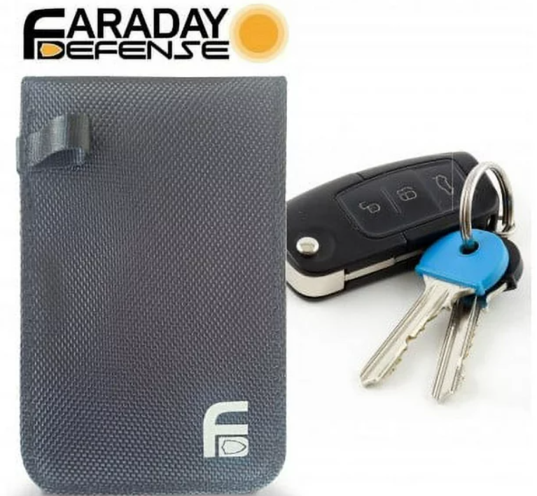 Faraday Jacket Anti Theft dry bag next to car keys and key fob, perfect for protecting electronics.