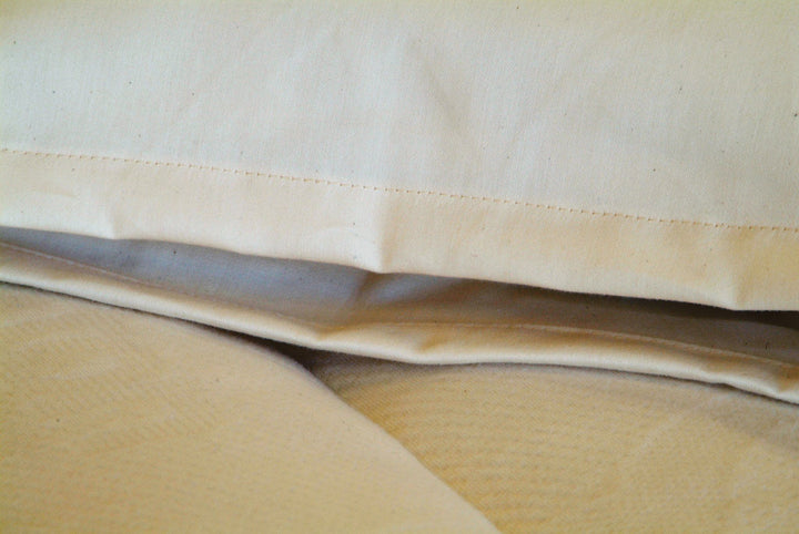 Holy Lamb Organics Travel Pillow showcasing its natural cotton and wool cover for ultimate comfort.