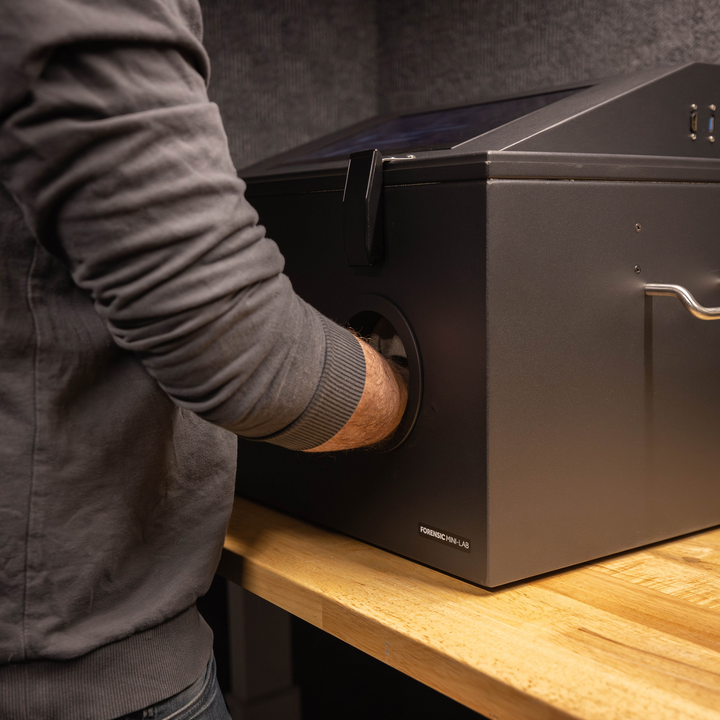 Person using the Faraday NEXUS Forensic Mini Lab RF shielded data protection box in a workspace.