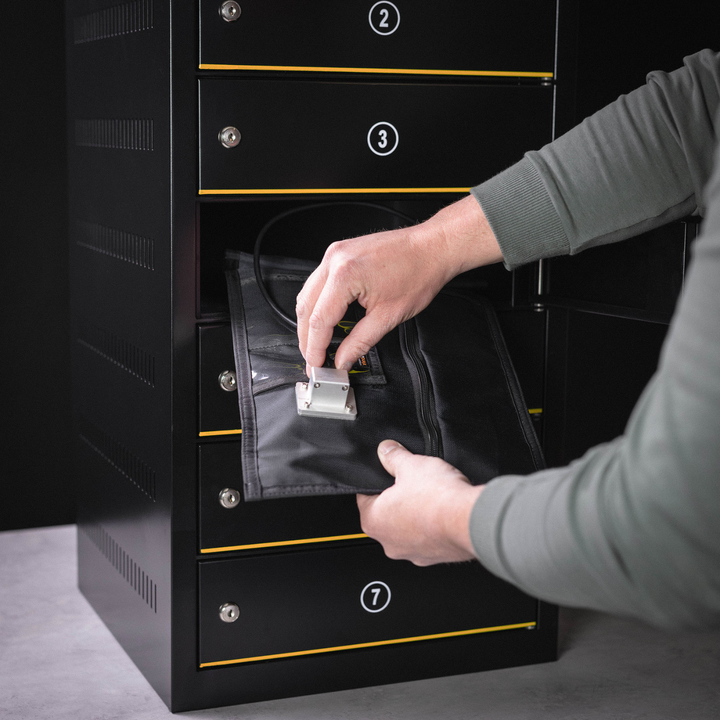 Person placing the Faraday JACKET Pro Window Port Bag into a secure storage unit.