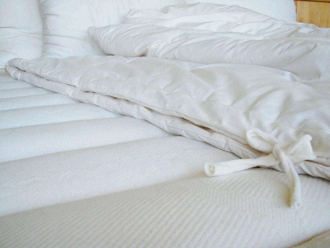 Holy Lamb Organics Comforter eco wool all season full/queen 86” x 86” on a bedspread.