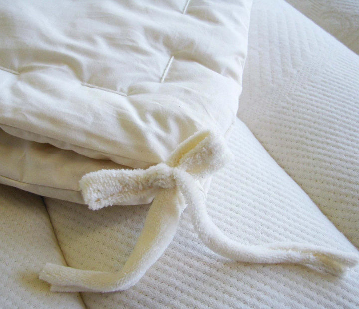 Close-up of the Holy Lamb Organics Comforter showing the soft fabric and tie details, perfect for all seasons.