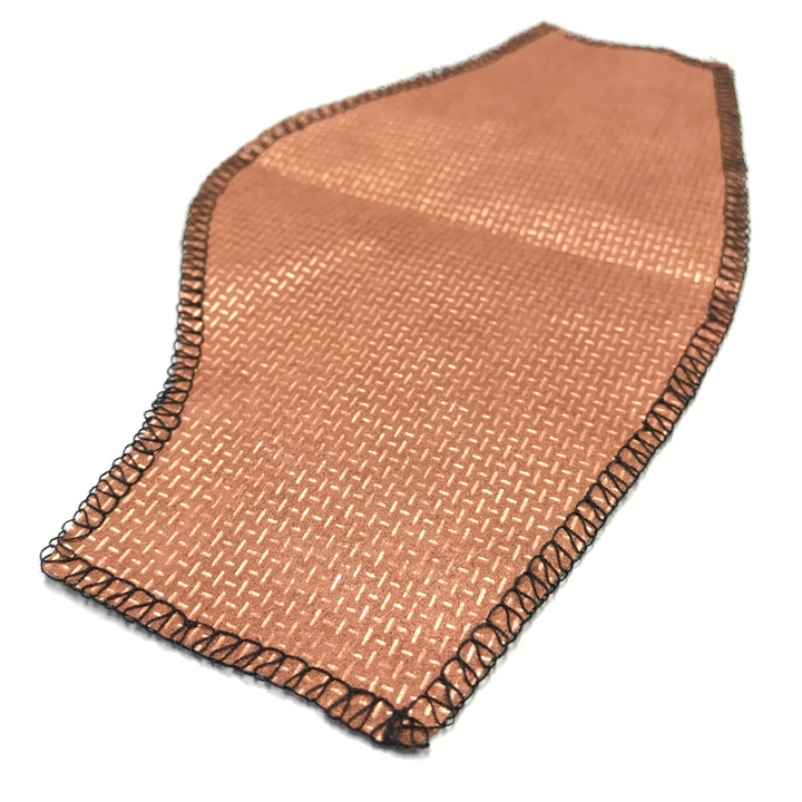 Faraday Cyber CX 100 non woven copper fabric piece with a woven edge, showcasing its conductive material and texture.