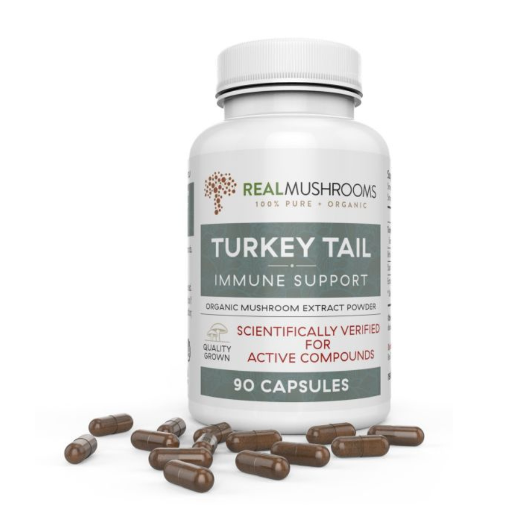 Real Mushrooms Turkey Tail Extract Immune Support 90 Capsules on a white background with capsules scattered around.